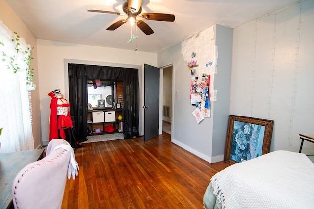 bedroom featuring wood finished floors, ceiling fan, baseboards, and visible vents