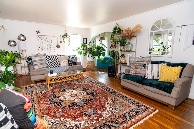 living room with arched walkways and wood finished floors
