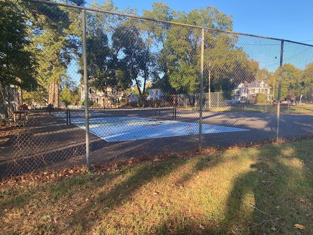 view of tennis court featuring fence