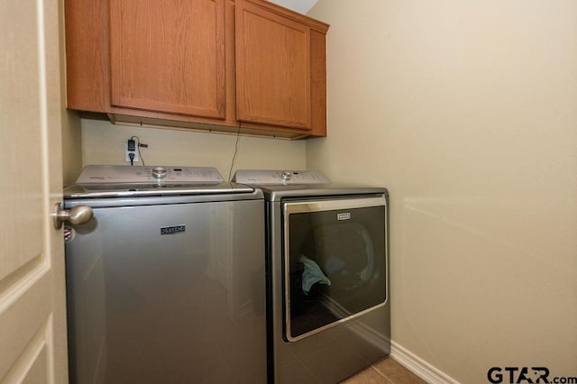 11017 Westhaven Cir, Flint, TX 75762 - laundry room featuring independent washer and dryer, cabinet space, and tile patterned flooring