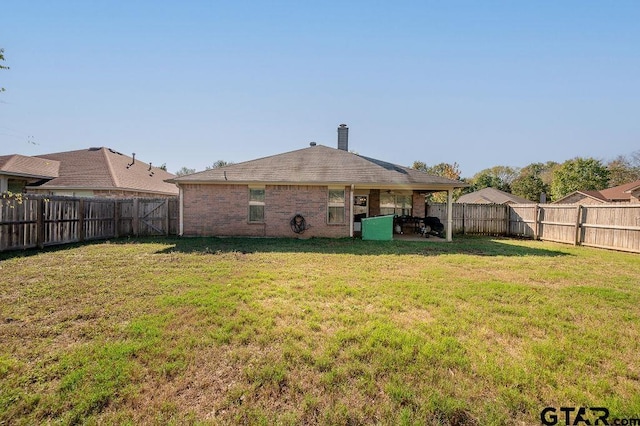 11017 Westhaven Cir, Flint, TX 75762 - back of property with a fenced backyard, a patio, brick siding, and a chimney
