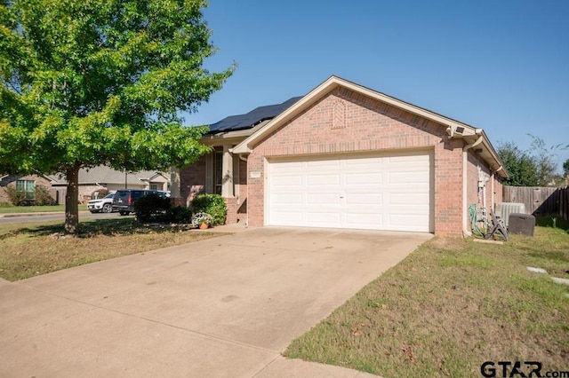 11017 Westhaven Cir, Flint, TX 75762 - ranch-style home featuring brick siding, an attached garage, solar panels, and driveway
