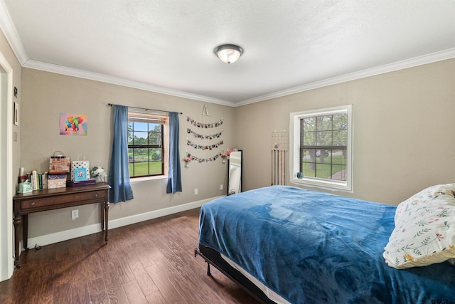 bedroom with a textured ceiling, multiple windows, dark hardwood / wood-style floors, and ornamental molding