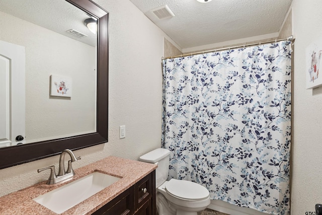 bathroom featuring a shower with curtain, vanity, toilet, and a textured ceiling