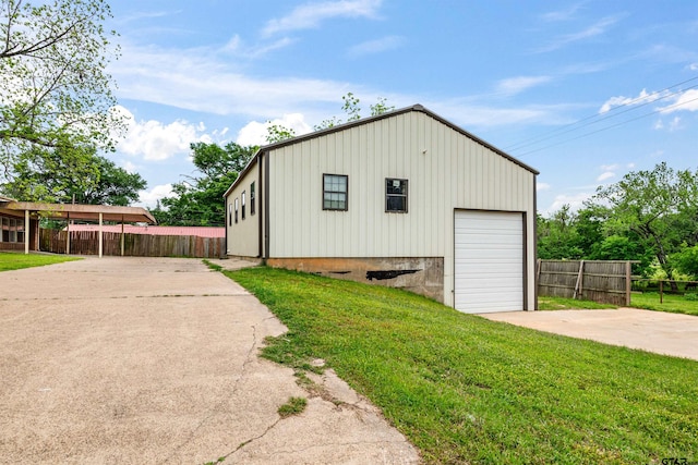 view of outbuilding with a yard and a garage