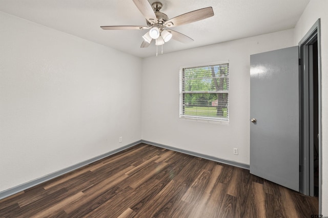 spare room featuring ceiling fan and dark hardwood / wood-style floors