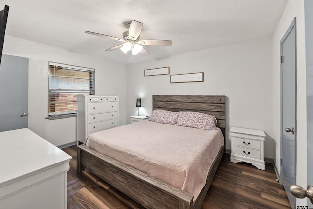 bedroom with ceiling fan and dark wood-type flooring