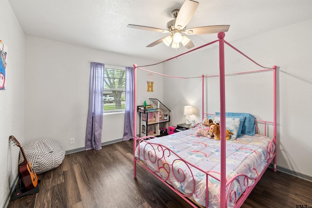 bedroom with ceiling fan and dark hardwood / wood-style floors