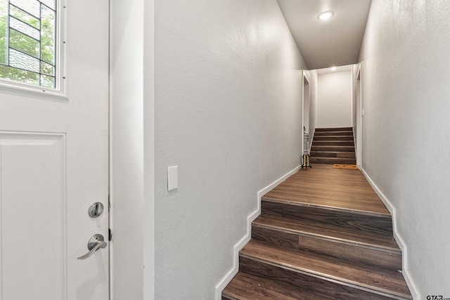 stairs featuring wood-type flooring