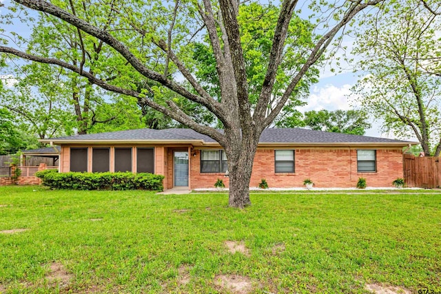 single story home with a front lawn and a sunroom