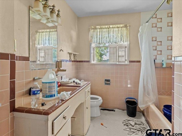 full bathroom with toilet, vanity, tile walls, and shower / bath combo with shower curtain