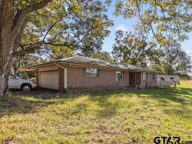 ranch-style house with a front lawn and a garage