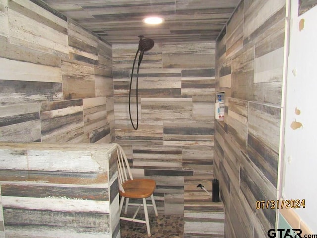 bathroom featuring wood walls, a shower, and wooden ceiling