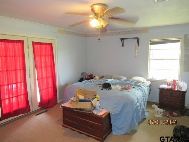 bedroom featuring ceiling fan, carpet floors, and ornamental molding