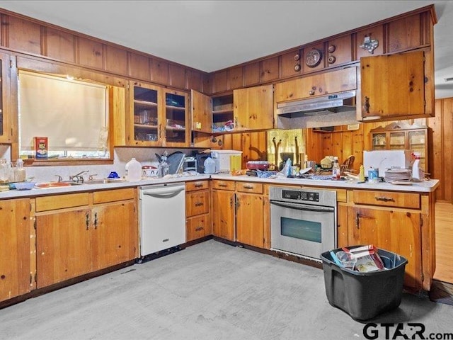 kitchen featuring white dishwasher, gas cooktop, sink, and stainless steel oven