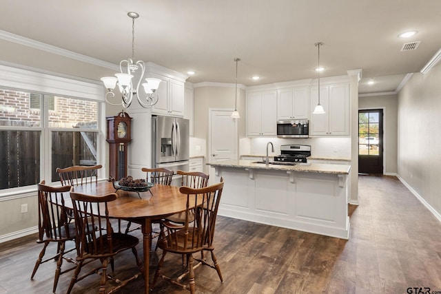 dining area featuring a chandelier, dark wood-type flooring, sink, and crown molding