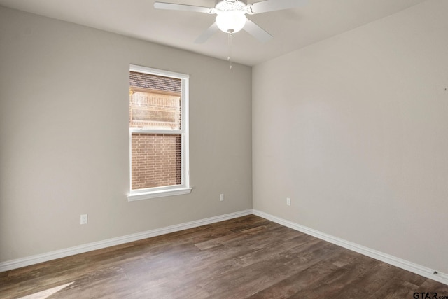 empty room with ceiling fan and dark hardwood / wood-style floors