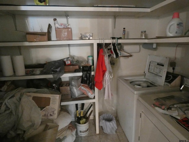 laundry room featuring washer and clothes dryer and light tile patterned floors