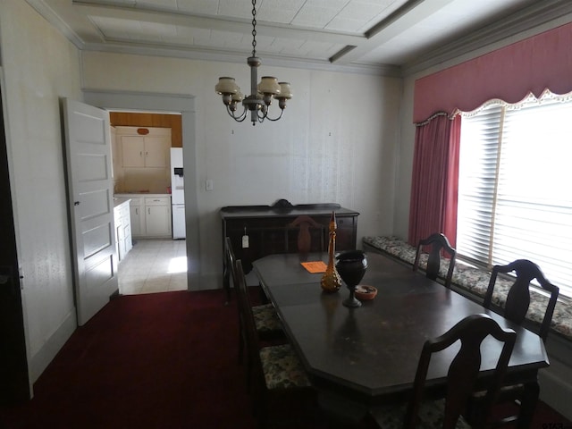 dining room featuring light tile patterned floors, ornamental molding, and an inviting chandelier