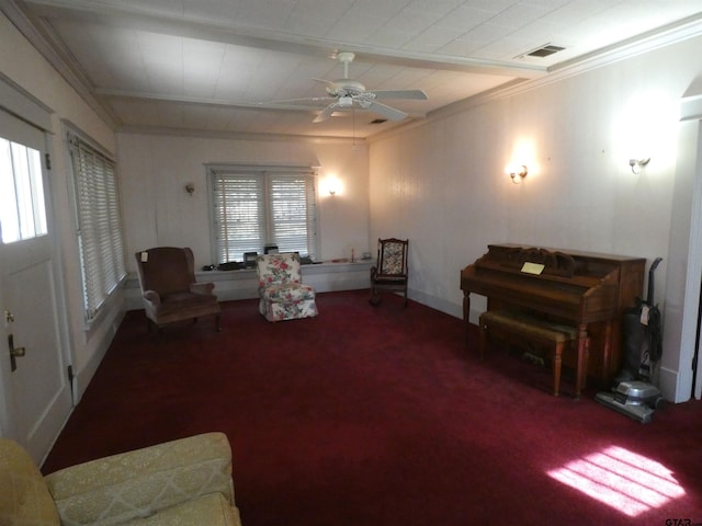 living area featuring crown molding, carpet, and ceiling fan