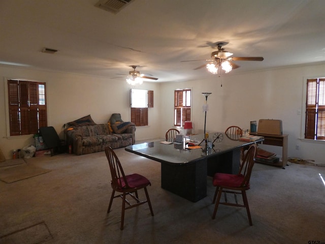 carpeted dining space featuring ceiling fan