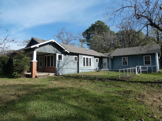 back of property with a yard and a patio