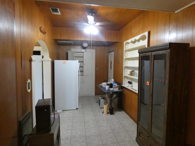 kitchen featuring wooden walls, ceiling fan, wood ceiling, and white refrigerator