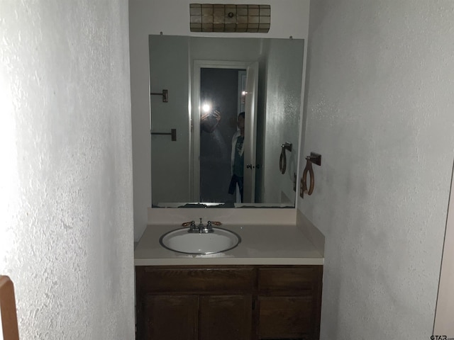 8307 Garrett Dr, Tyler, TX 75703 - bathroom featuring vanity and a textured wall