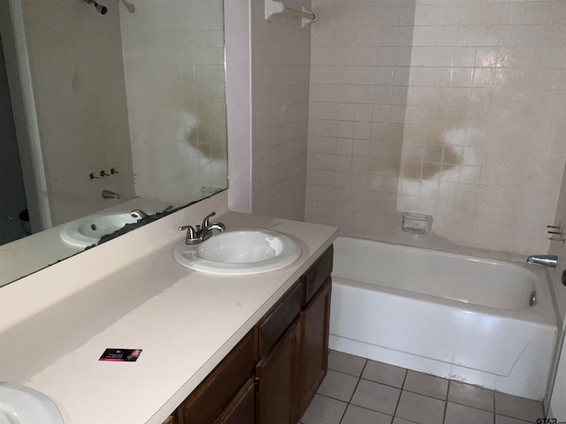 bathroom featuring vanity, tiled shower / bath combo, and tile patterned floors