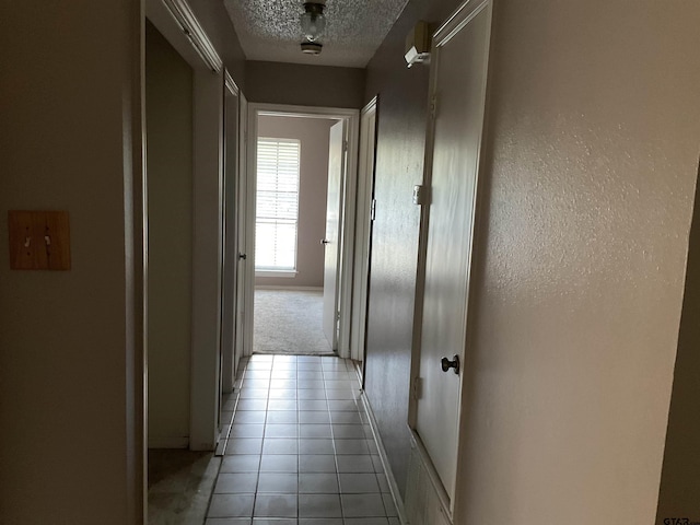 8307 Garrett Dr, Tyler, TX 75703 - hall with a textured ceiling and light tile patterned floors