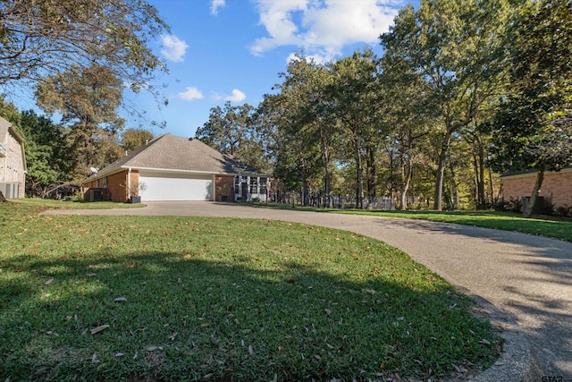 view of front of property featuring a front yard and a garage