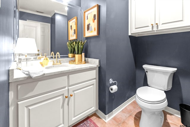 bathroom featuring vanity, crown molding, tile patterned floors, and toilet