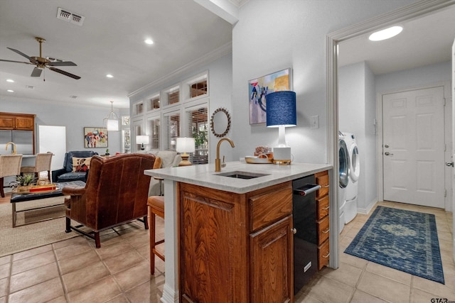 kitchen with ornamental molding, ceiling fan, stainless steel fridge, sink, and light tile patterned flooring