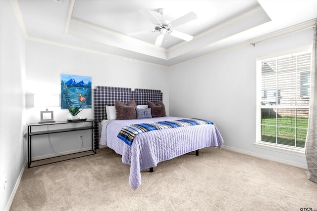 bedroom with a raised ceiling, ornamental molding, light carpet, and ceiling fan