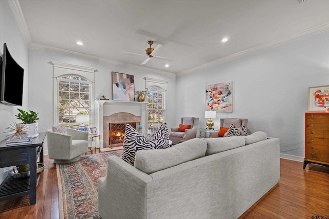 living room with hardwood / wood-style floors, ceiling fan, and ornamental molding