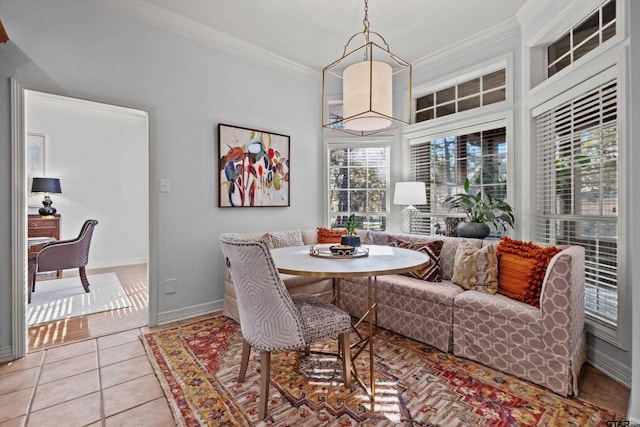 tiled dining area with plenty of natural light, crown molding, and breakfast area