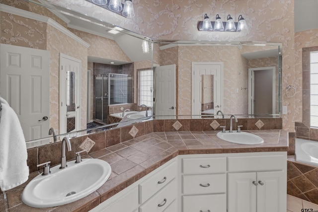 bathroom with vanity, ornamental molding, vaulted ceiling, and separate shower and tub