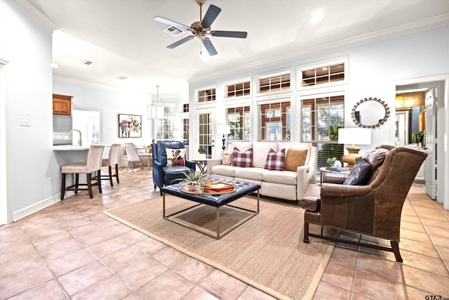 tiled living room featuring sink, ornamental molding, and ceiling fan