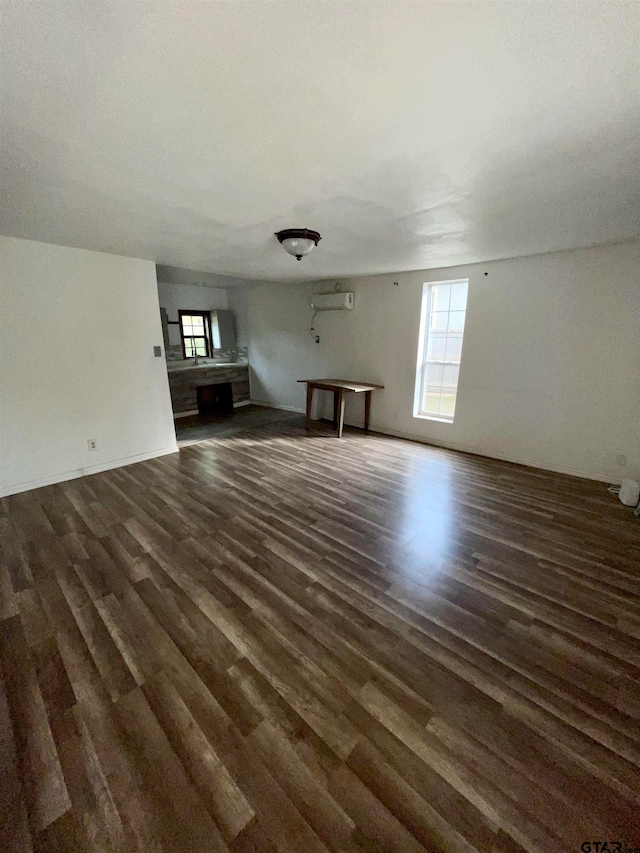 unfurnished living room with dark wood-type flooring