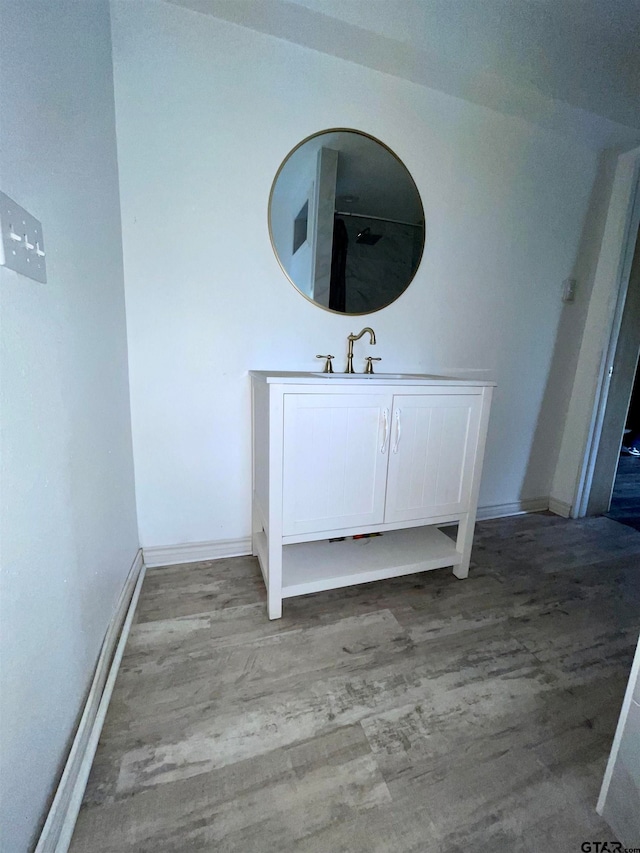 bathroom with hardwood / wood-style floors and vanity