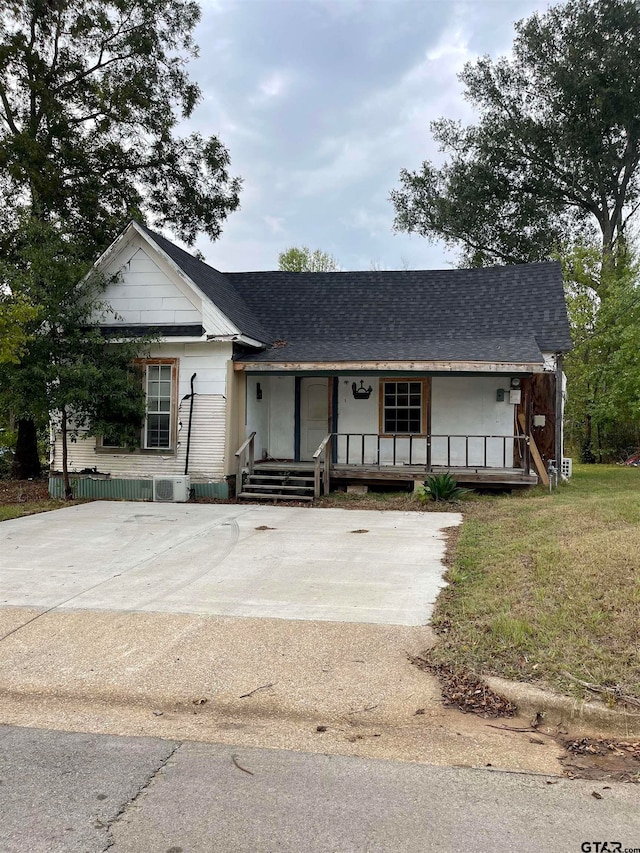 view of front of home with a front yard and a porch