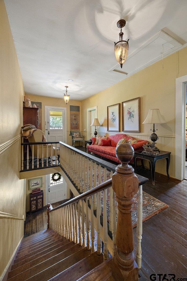 502 E Montgomery St, Crockett, TX 75835 - stairway with attic access, wood-type flooring, and a wainscoted wall