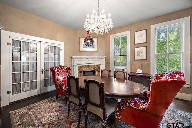 502 E Montgomery St, Crockett, TX 75835 - dining area with wood finished floors, a chandelier, a high end fireplace, and a wainscoted wall