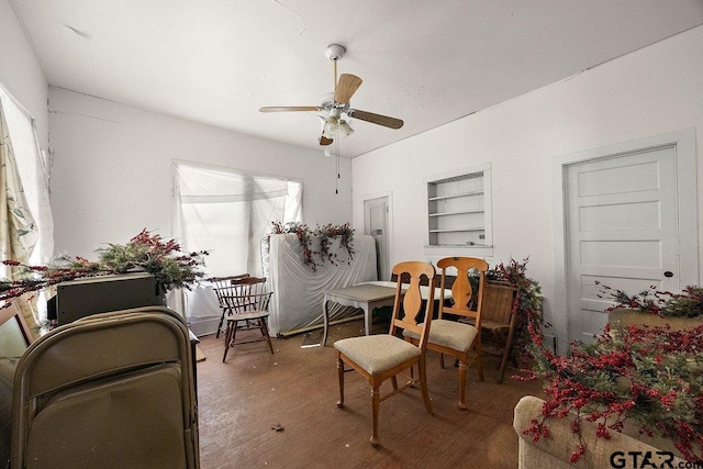 502 E Montgomery St, Crockett, TX 75835 - living area with built in shelves, a ceiling fan, and wood finished floors