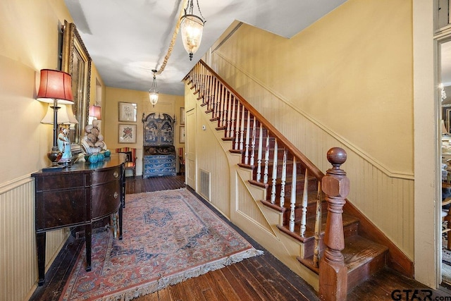 502 E Montgomery St, Crockett, TX 75835 - staircase with wainscoting and hardwood / wood-style floors