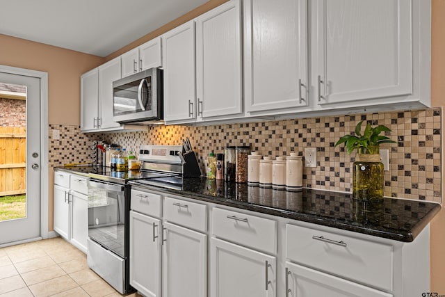 553 Princess Pl, Tyler, TX 75704 - kitchen with stainless steel appliances, white cabinetry, dark stone counters, and decorative backsplash