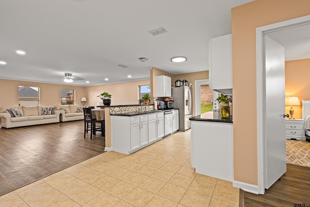 553 Princess Pl, Tyler, TX 75704 - kitchen featuring dark countertops, white cabinetry, visible vents, and stainless steel appliances