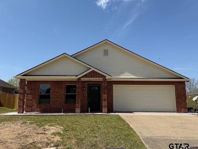 553 Princess Pl, Tyler, TX 75704 - single story home with concrete driveway, an attached garage, a front yard, brick siding, and fence