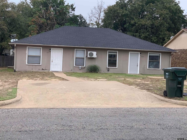 single story home with a wall mounted AC