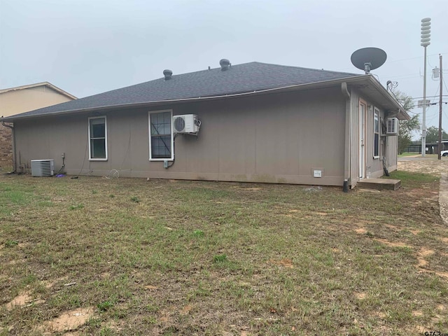 view of property exterior featuring central air condition unit and a yard